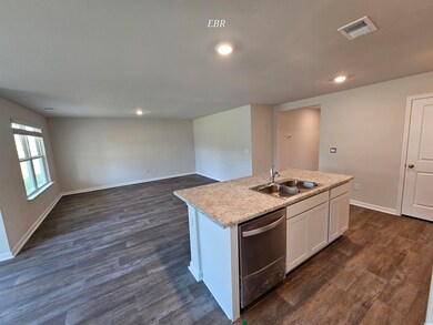 Kitchen featuring a sink, visible vents, a center 