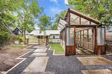 Rear view of property featuring an exterior struc