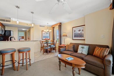 Living room with visible vents, ceiling fan with n
