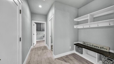 Mudroom with baseboards, light wood-style floors, 