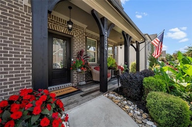 Doorway to property with brick siding and a porch
