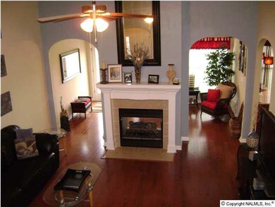 A MUST SEE GREAT ROOM WITH 13 FOOT VAULTED CEILING, GLEAMING HARDWOOD FLOORS, ARCHED ENTRY WAYS TO ALL MAIN LEVEL LIVING AREA, AND A DOUBLE SIDED GAS LOG FIREPLACE.