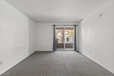 Carpeted empty room featuring baseboards and a tex