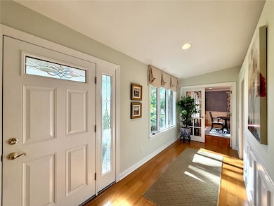Entryway with light wood finished floors, recessed lighting, and french doors