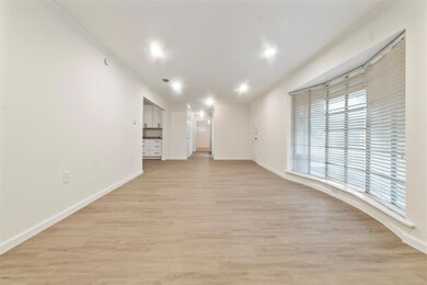 Unfurnished living room with ornamental molding an