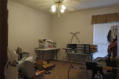 Office with a textured ceiling and ceiling fan