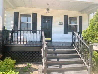 COVERED FRONT PORCH GREETS YOU