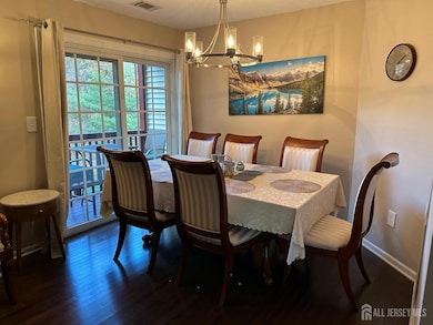 Dining area opens to a private balcony overlooking open space.