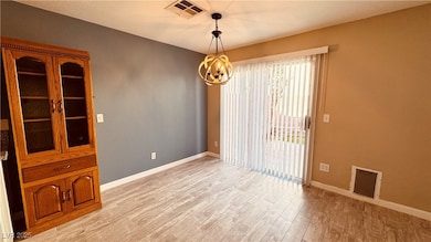 Unfurnished dining area with a chandelier and ligh