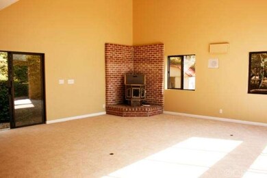 Family room with pellet stove. Garden shed outside