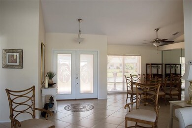 light filled double door entry, large neutral tile