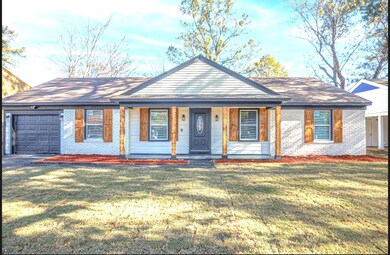 Ranch-style house featuring covered porch, a front