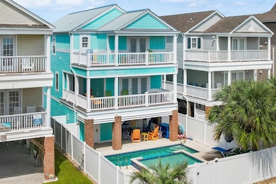 Back of house with a balcony, a fenced in pool, an
