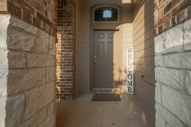 The welcoming front porch, framed by rich stone an