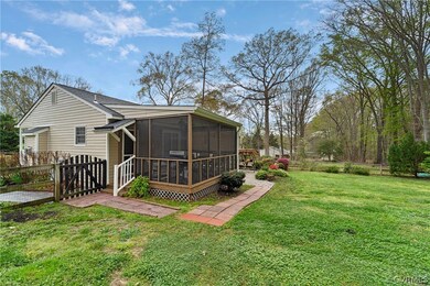 Rear view of property featuring a sunroom and a la