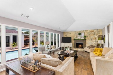 The living room features fireplace, high ceilings