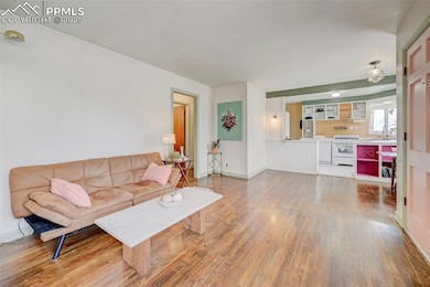 Living room with wood finished floors and baseboar
