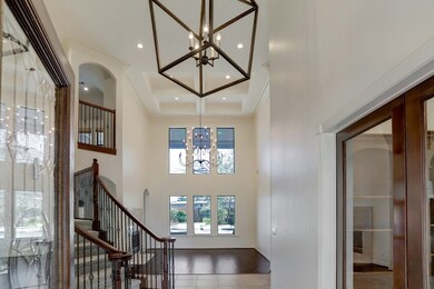Gorgeous updated chandeliers, LED lights, dramatic high ceilings in the foyer and intricate tray ceiling in the formal living are sure to wow guests as they enter through the front door.