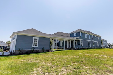 Back of house featuring a yard