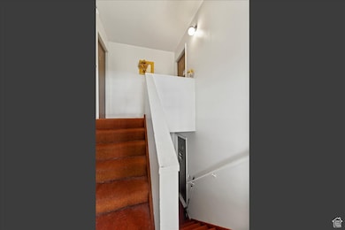 Staircase featuring wood finished floors