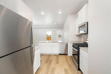 Modern white cabinetry and a full set of Whirlpool