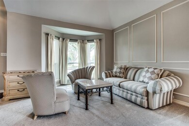 Natural light streams through the beautiful bay windows in the formal living area