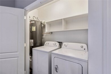 Washroom featuring electric water heater and separ