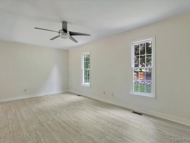 Large living room with new floors, fresh paint and