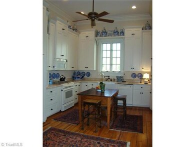 Kitchen. Marble Countertops, Paneled Refrigerator, Gas Range Top with Electric Oven, Farmhouse Sink, Microwave, Dishwasher, Hardwood Floors