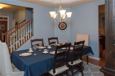 Formal dining area features a tray ceiling for an 