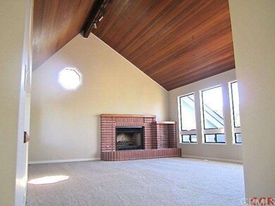 Beautiful wood ceilings and brick fireplace enhanc
