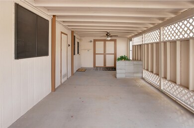 Comfortable carpeted primary bedroom complete with a ceiling fan and ample closet space.
