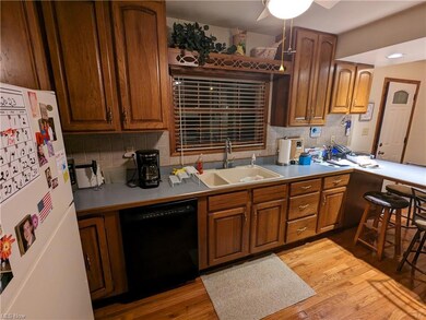 Kitchen with a kitchen island, black dishwasher, b
