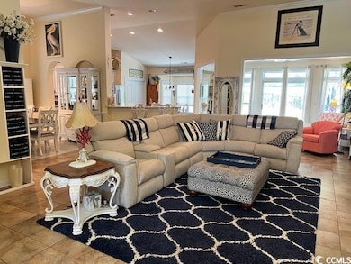 Living room with tile patterned floors, recessed l