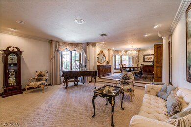 The sunken living room is marked with crown moldin