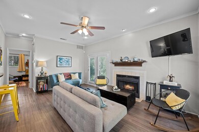 Living room featuring a tile fireplace, visible v