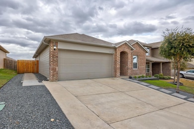 View of front of home with brick siding, driveway