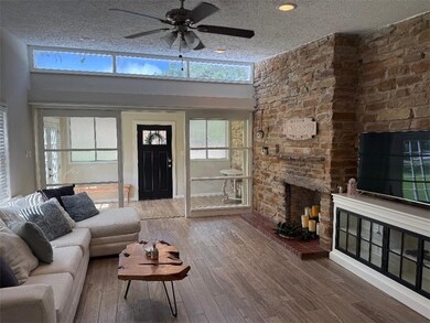 Living area with a fireplace, wood-type flooring,