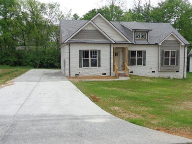 Concrete drive. Home is close to schools and shopping.