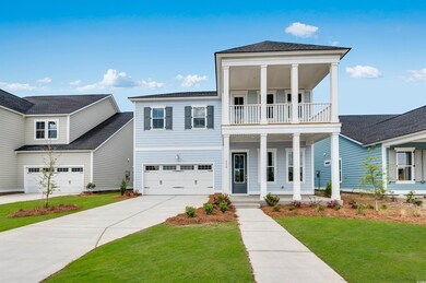 View of front of home featuring a balcony, covered porch, a front lawn, concrete driveway, and a garage