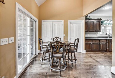 Breakfast area with hardwoods, opens to the back covered porch