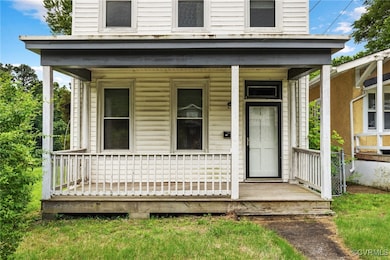 Doorway to property featuring a porch