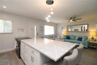 Kitchen with hanging light fixtures, sink, white c