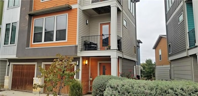 View of front of home with a balcony and an attac