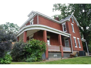 Exterior Front. The porch wraps from the side of t