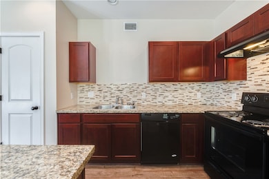 Kitchen with decorative backsplash, a sink, extrac
