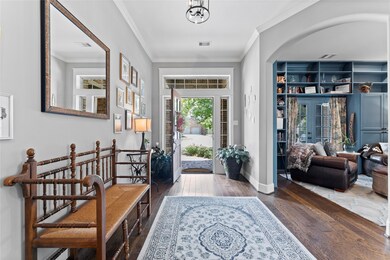 As you enter, the sitting area has french doors that lead to the front porch and custom built ins.