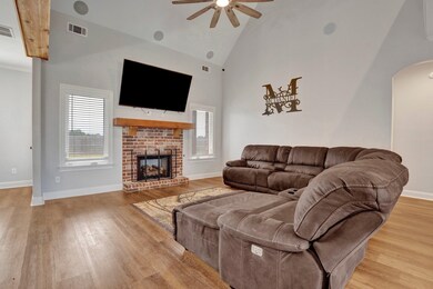 Living room with high vaulted ceiling, a fireplace