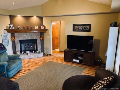Living room with vaulted ceiling and brick wood bu