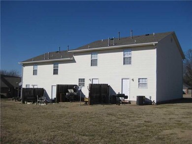 Exterior Back. View of the individual patios in the back with privacy fence separation.